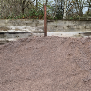 Loose granite grano dust aggregate sold by the tonne for commercial block paving, artificial grass sub-bases, and bedding work.