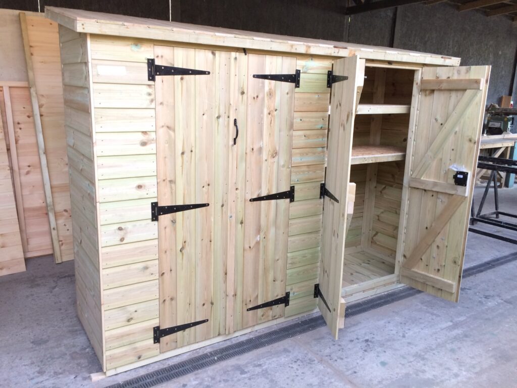 Extra-wide timber garden storage unit featuring two sets of double doors and internal shelving, handcrafted in our workshop near Hertford for easy-access garden storage.