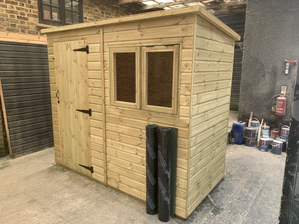 A new timber pent roof garden shed with two windows and side door handcrafted in our Hertfordshire workshop by 414 Fencing.