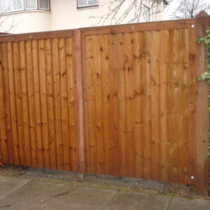 A bespoke workshop-manufactured timber closeboard double driveway gate system installed between heavy posts near Harlow.
