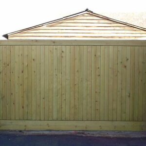 A bespoke workshop-manufactured softwood vertical tongue and groove sliding driveway gate set up for manual or automated opening in Harlow.