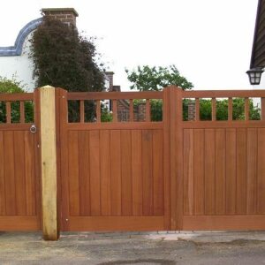 Matching bespoke Utile hardwood driveway and pedestrian gates with integrated vision panels, handcrafted for a property in Essex.