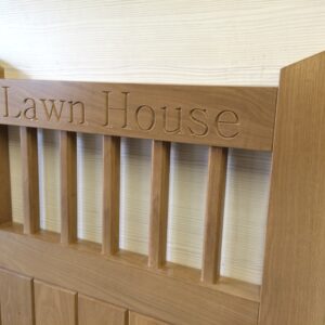 A custom workshop-manufactured premium Iroko hardwood bespoke garden gate featuring engraved text for a property near Harlow.