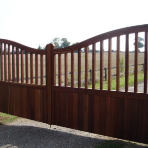 Bespoke handcrafted Utile hardwood driveway gates with tongue and groove infill and a dipping vision panel, manufactured at our Hertfordshire premises.