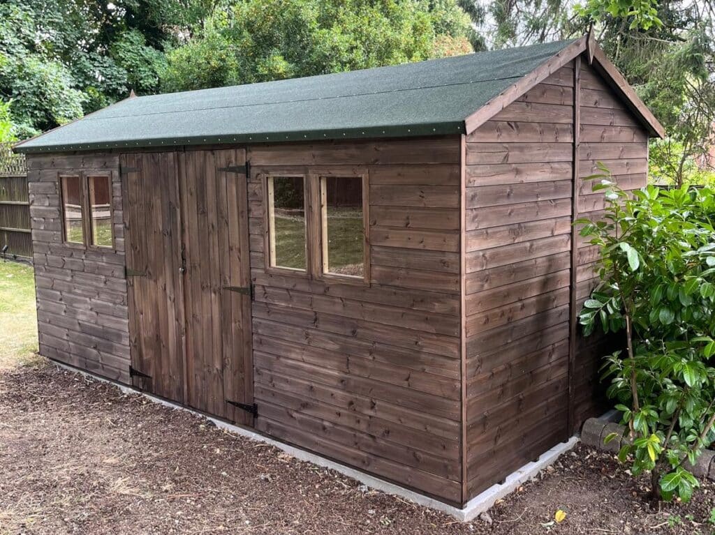 Stained dark timber apex garden shed, available for collection near Hertford and Harlow.