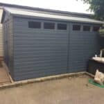 Modern dark grey garden shed with high-level windows, supplied by 414 Fencing & Timber Supplies.